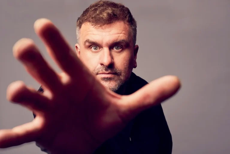 Jon McClure of Reverend and the Makers posing for a promo photo, reaching for the camera.