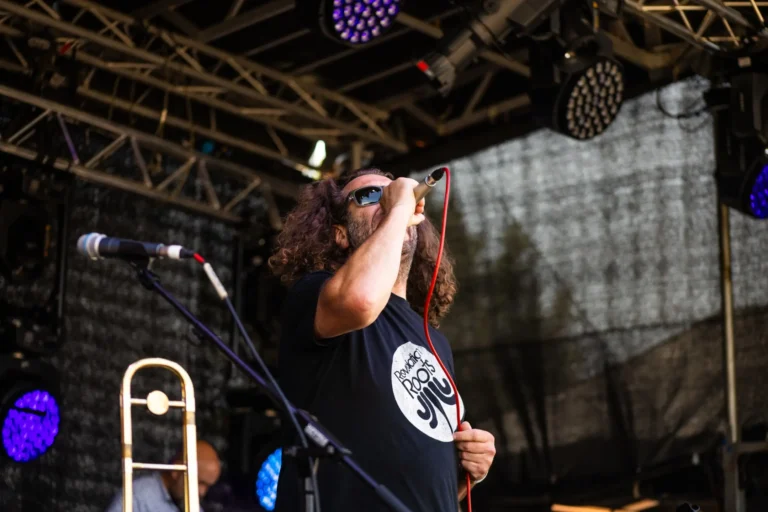 The vocalist from Revelation Roots singing on stage.